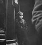 HUNGER WINTER. Boy outside blackmarket restaurant hoping for food handout. Kids often carried spoon 'just in case' 1944-1945