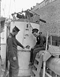 Seamen J. McKenna and G. Brown inspecting damage to a "D"-type motor torpedo boat of the 65th Flotilla, Royal Navy, England, 25 May 1944 May 25, 1944