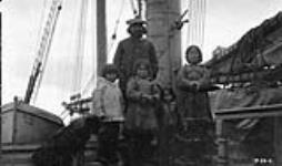 Kakto and family on board C.G.S. ARCTIC [Qaktu, his wife, Oolayoo (far right) and their family en route to Devon Island. Their daughter Oopikjuya (Rhoda) Allooloo is the girl in the centre.] 1922.