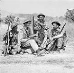 H/Captain S.B. East, a chaplain, talking with soldiers of the 48th Highlanders of Canada near Regalbuto, Italy, July-August 1943 July-August 1943.