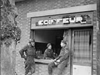 Personnel at the temporary office of the 8th Field Squadron, Royal Canadian Engineers (R.C.E.), Calmpthout, Belgium, 23 October 1944 23-Oct-44