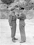 General Sir Bernard Montgomery, Commander of the 21st Army Group (British Army), decorating Lance-Corporal Russell Geddes of the 1st Canadian Parachute Battalion with the Military Medal during an investiture in Normandy, France, 16 July 1944 July 16, 1944.