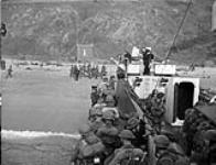 Unidentified Canadian infantrymen prepare to go ashore from a Landing Craft Infantry (Large) of the Royal Canadian Navy during a training exercise, England, May 1944 May, 1944