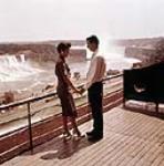 Couple on platform overlooking Niagara Falls ca. 1960