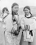 Inuit mother and baby and a friend. [Miali Mike with baby Meeka Kilabuk in an "amauti" (left) and Evie Anilniliak (right).] 1950