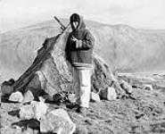 Young Inuit man in front of a topek. [Solomonie Nukiruak] 1950