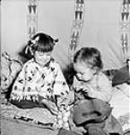 Alex One Spot and his sister Linda from the Tsuut'ina First Nation in a teepee during the Calgary Stampede, Alberta July 1945