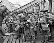 Three sergeants of the Royal Berkshire Regiment (British Army) disembarking from H.M.C.S. PRINCE DAVID on D-Day, France, 6 June 1944 June 6, 1944.