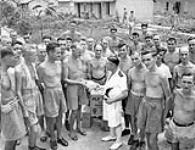 Lieutenant-Commander Fred Day of H.M.C.S. PRINCE ROBERT meeting with liberated Canadian prisoners-of-war at Shamshuipo Camp, Kowloon, Hong Kong, September 1945 September 1945