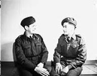 Reunion of cousins Flight Sergeant Maurice H. Depot (left), No.425 (Alouette) Squadron, Royal Canadian Air Force (R.C.A.F.), and Private Camille Gagnon, recently discharged from the First Special Service Force, London, England, 7 April 1945 Apri1 7, 1945.