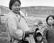 [Inuit woman displays handicraft (Elisapee Kanana, Jayko Tunraq and Enoya Shooyoojk)] n.d.