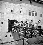 Canadian soldiers disembarking from an unidentified troopship on arrival in Britain, 24 June 1943 June 24, 1943.