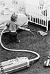 Small child seen vacuuming the baby's room / Jeune enfant passant l'aspirateur dans la chambre de bébé 1978