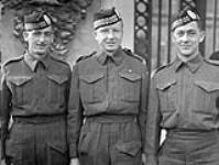 Private Leonard A. Middleton (centre) of The Toronto Scottish Regiment, who received the Military Medal during an investiture at Buckingham Palace, London, England, 27 October 1942 October 27, 1942.