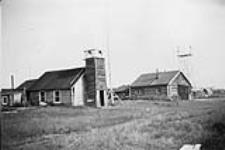 Anglican church Mission and Mounted Police Barracks, Old Crow, Yukon c 1948