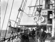 Unidentified Innu pilot and captain [Wakeham] on bridge of "Diana" 18 Sept. 1897.