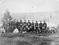 The selected ten of the New Westminster volunteers after a match with the Navy - who being conquered may be seen reposing in the foreground 1867