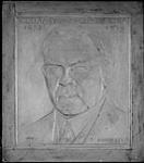 Plaster model for proposed plaque in memory of William Lyon Mackenzie King featuring a portrait of King and dates 1875-1950 1950