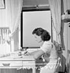 Celine Perry, a female employee at the Dominion Arsenals Plant writes a letter home in her apartment 25 Aug. 1942