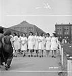 Des ouvrières des munitions font une promenade avec des amies à l'heure du déjeuner à l'usine Dominion Arsenals Ltd 24 Aug. 1942