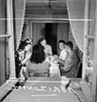 Female munitions workers at the Dominion Arsenals plant dining with friends Aug. 1942