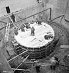 Workmen construct the scrole case of the No. 9 unit during the Shipshaw Power Development project janv. 1943