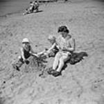Mme Jack Wright et ses deux fils, Ralph et David Wright, passent une journée à la plage sept. 1943