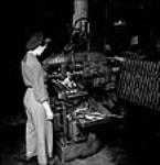 Female worker Eileen Dagg operating a straddle milling trunion block at the John Inglis Co. plant producing .303 Vickers machine gun barrels May 1944
