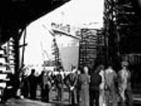 Workmen gathered to witness the launch of the 300th cargo vessel from the Burrard drydocks mai 1944