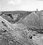 Vue d'un semi-chenilles de 10 tonnes transportant du minerai d'amiante sur une pente inclinée de 25 degrés à Thetford Mines juin 1944