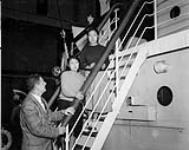 Seeya (E7-58) and Ninquapik (E7-103), Inuit girls who are returning to Lake Harbour [Kimmirut (formerly Lake Harbour), Nunavut] aboard C.G.S. C.D. Howe after medical treatment in southern Canada 1950.