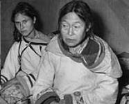 [Inuuk women, Ootoovak Tigullaraq, and Ekerak (Ikirat) Paipak. Baby is Riipika (Rebecca) Ootoovak] Inuit 1950