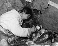 [Inuk woman, Arnaujumajuq Piungittuq Qillaq, trimming a kudlik] Inuit woman trimming a kudlik 1950