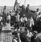 Inuit men and boys aboard the Eastern Arctic Patrol ship M.V. Regina Polaris after trading with the crew members 1948.