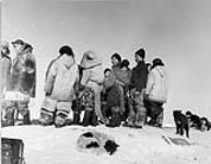 A group of Inuit with Dr. Simpson and Dave Croll on the left 1949