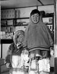 Two Inuit boys inside the Hudson's Bay Company store [Marius Qilluaq (Killuck, Kidluak) on the left and Donat Milurtuq (Milurtok) on the right.] 1953