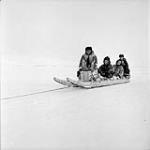 Governor General's Northern Tour. (Right to Left:) Governor General Vincent Massey and Mrs. Lionel Massey R.C.M.P. Constable Bertram Arthur "Art" Deer and an unidentified Inuit driver at Frobisher Bay, N.W.T March 1956.