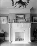 Unidentified domestic interior depicting fireplace and chairs ca. 1920s