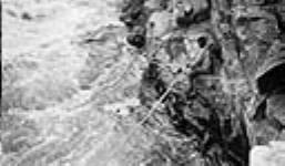 Kumaiak spearing fish June 1931