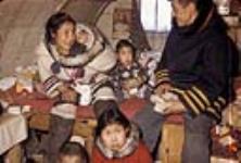 Inuit family inside a house 1950-1980
