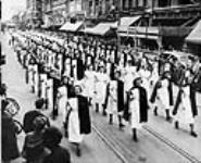 Nurses from General and Holy Cross hospitals and St. John's Ambulance Corps in Calgary march in parade to promote cancer awareness during a national campaign of the Canadian Cancer society c 1946