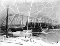 Quebec, Montreal, Ottawa & Occidental Ry. 17 and passenger train on bridge c. 1880