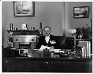 Sergeant-at-Arms of the House of Commons, H.J. Coghill sitting at his desk ca. 1930-1932