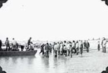 Group of Inuit men unloading cargo received from the M.V. Regina Polaris 1952