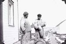 Two unidentified Inuit women outside Hudson's Bay trading post at Chesterfield Inlet 1952