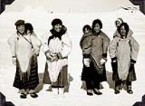 Four unidentified Inuit women with their children  [Left to right: Mrs. Salome Kalaserk, Mrs. Theresa Siksik, Mrs. Kukkiak and Mrs. Kubluitok.] 1952