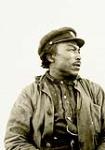 Profile of an unidentified Inuk man wearing a captain-style hat [graphic material] 1926