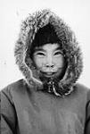 Portrait of an unidentified Inuit child wearing a parka with a fur-trimmed hood 195-?.