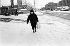 Monette, 37 years old, walks back from the variety store, where every Saturday she buys the Toronto Star and her parents' lottery tickets January, 2003