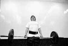 Michael Erruda, 18 years old, practices weight lifting, one of his many activities June, 2003